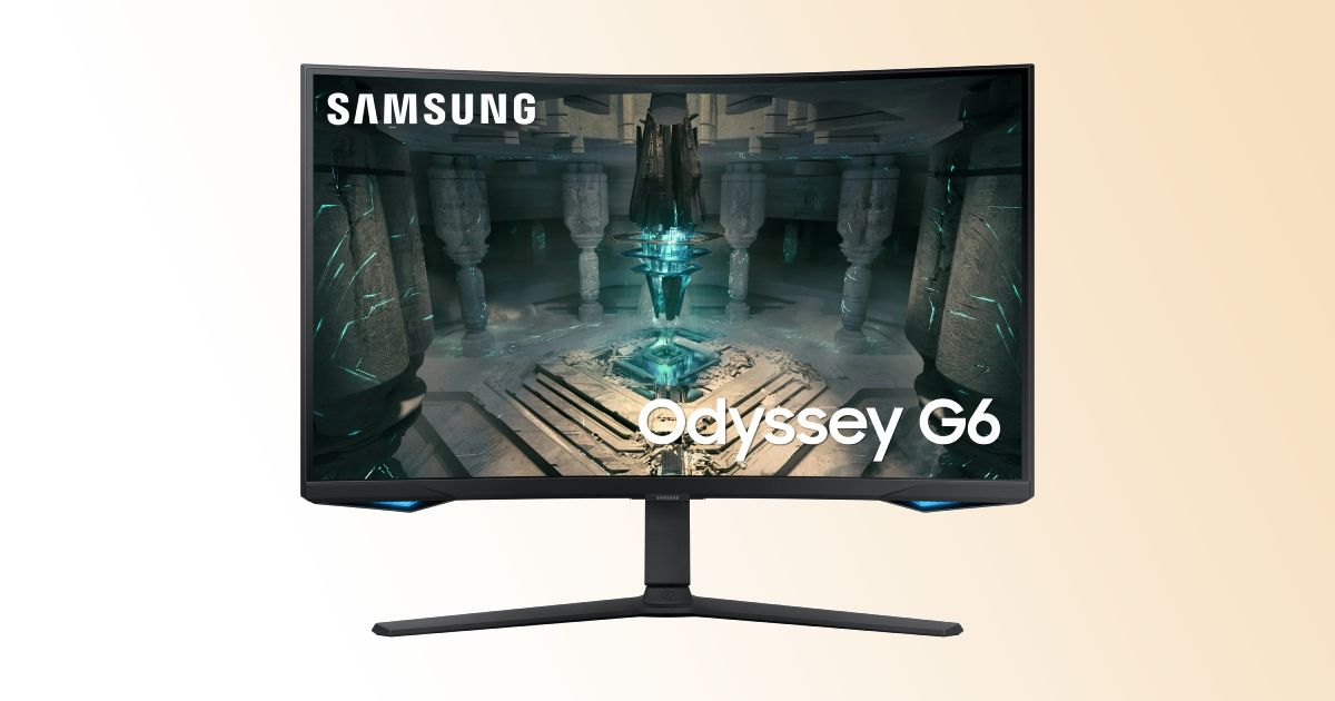 A black curved gaming monitor with a blue crystal in a stone cave on the display.