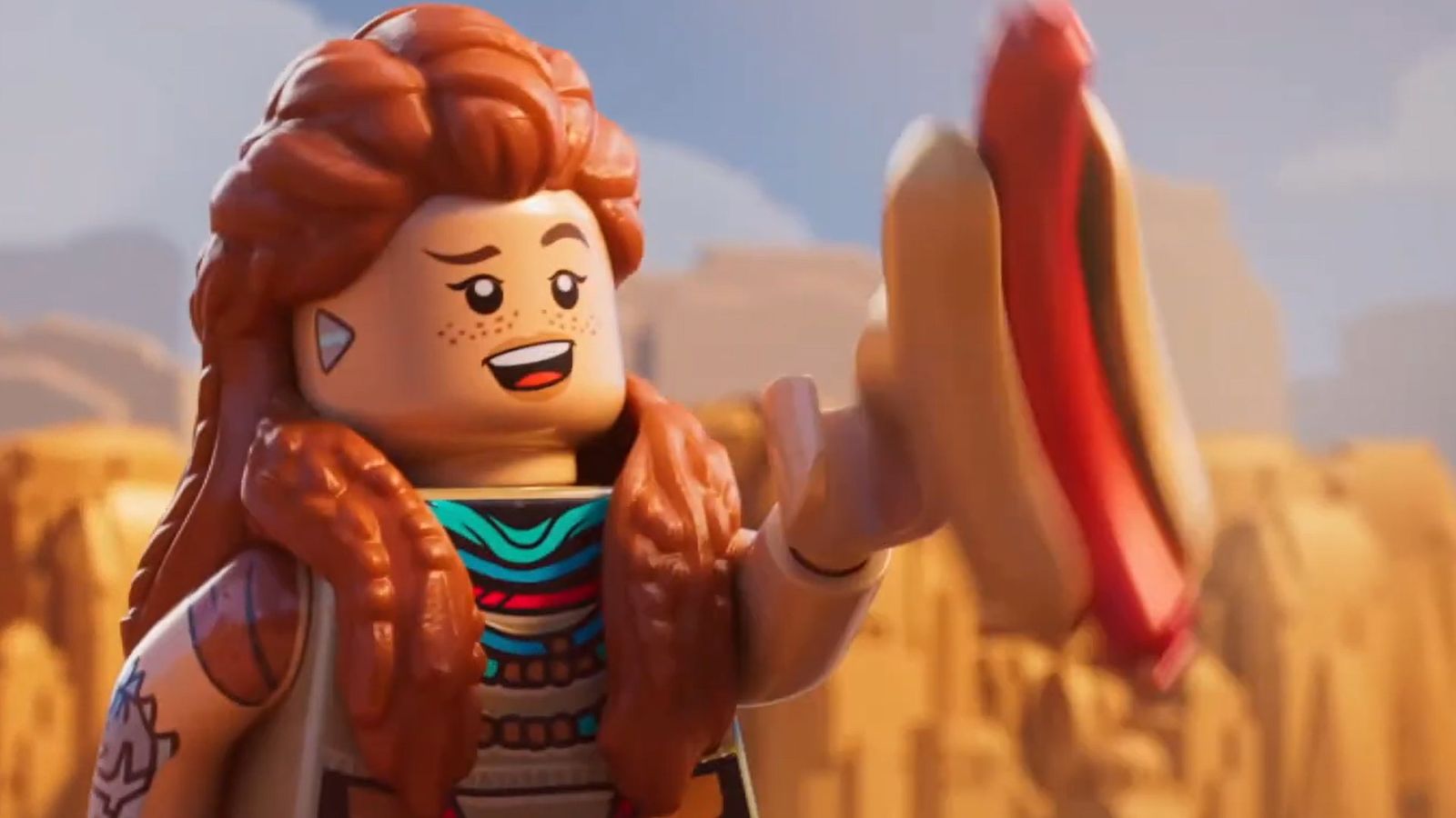 a lego figure is holding a hot dog in her hand .